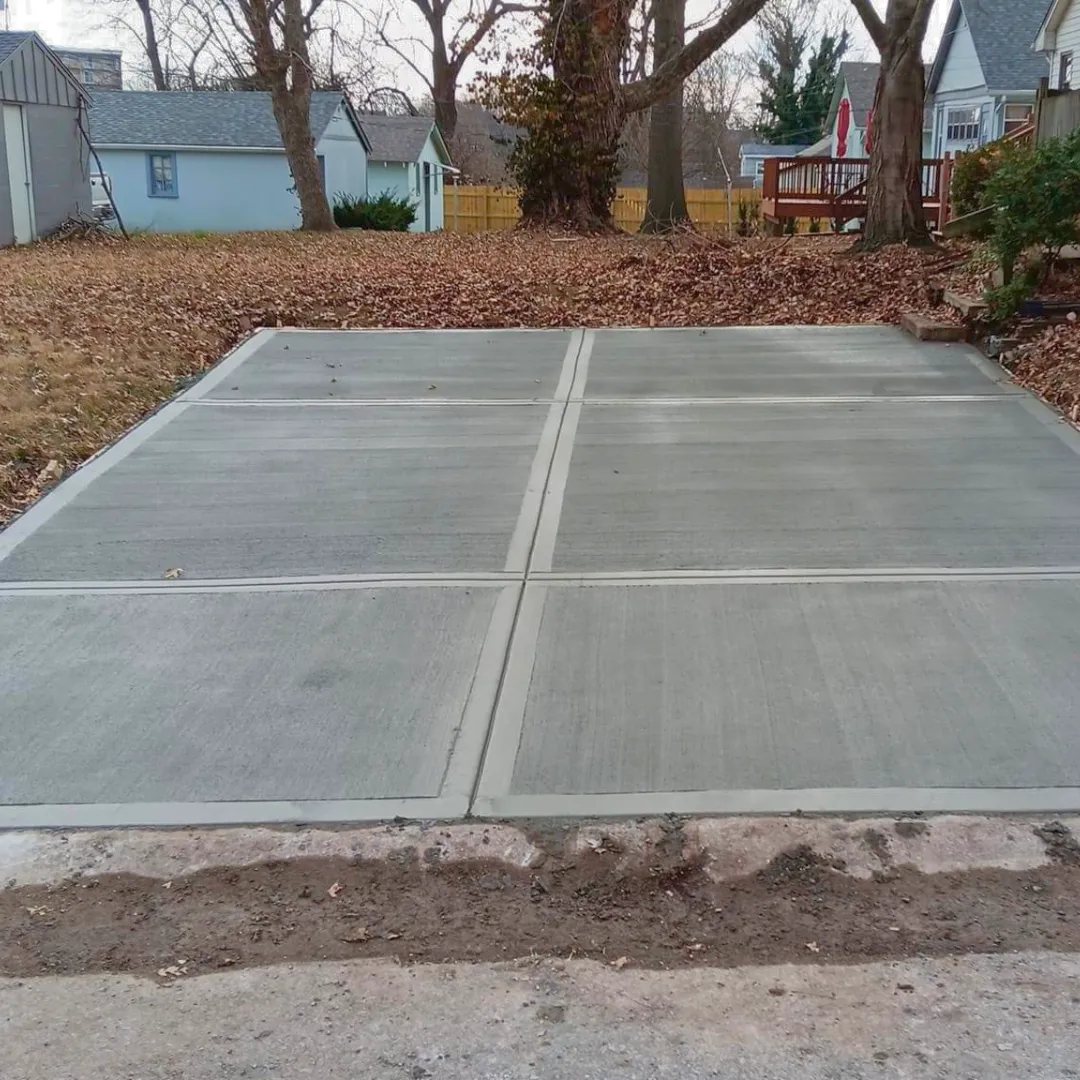 Freshly poured and finished concrete patio with smooth broom finish at residential property in Central Iowa